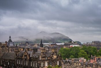city of edinburgh castle and hills in the background