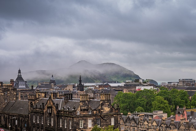 city of edinburgh castle and hills in the background