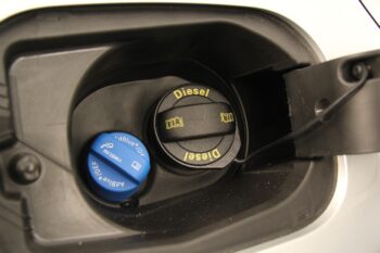 Image of a AdBlue filler cap next to a diesel filler cap