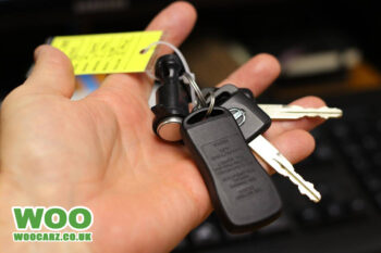 image of a set of car keys in a hand.