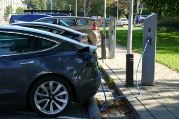 image shows a row of electric cars charging