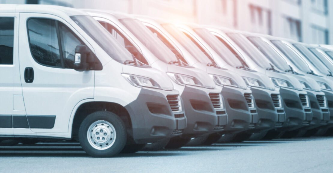 collection of white vans parked