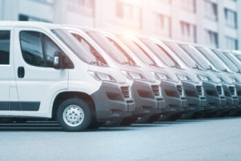 collection of white vans parked