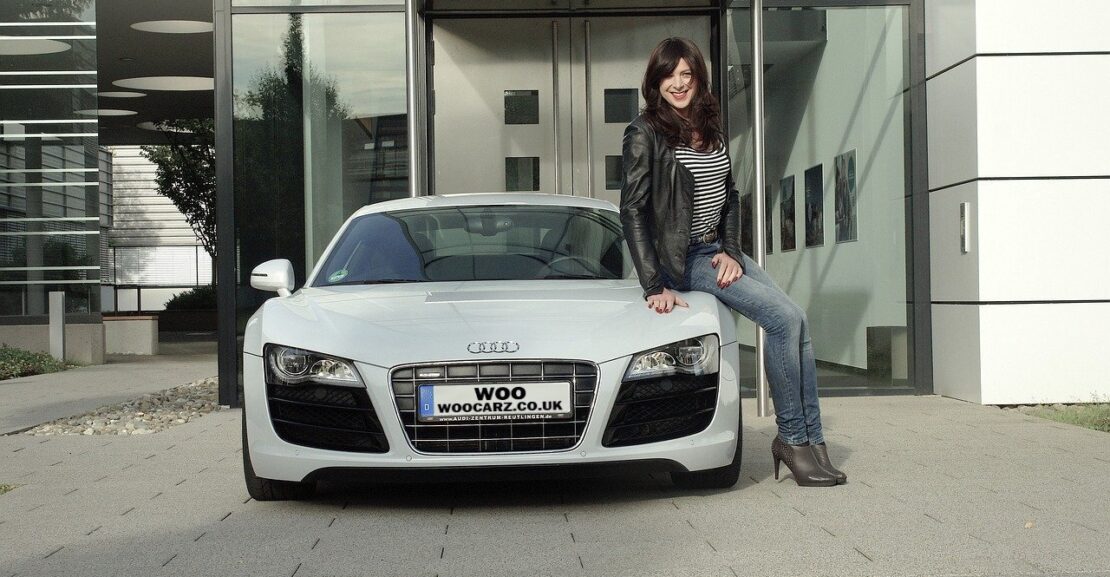 woman sitting on a white audi r8