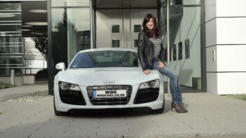 woman sitting on a white audi r8