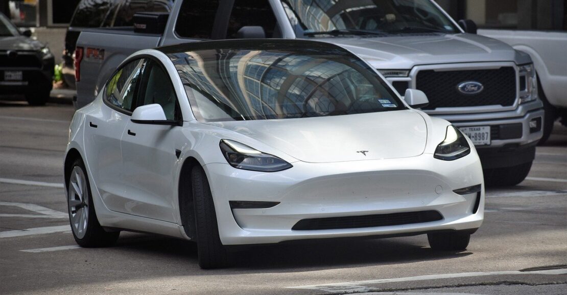 image of a white tesla car on the road