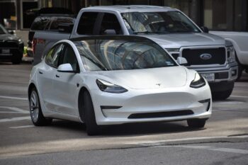 image of a white tesla car on the road